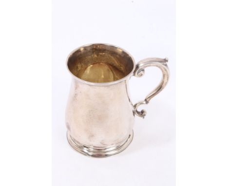 George II silver mug of baluster form, with scroll handle, on a circular foot, underside later stamped 3rd June 1919 from J. 