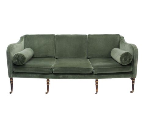 Regency three seater sofa with square back, upholstered in green velvet, raised on ebonised ring-turned supports and castors,