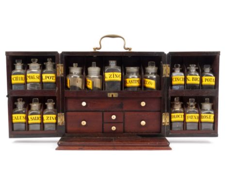 Early 19th century mahogany apothecary cabinet with surmounting swing handle and fitted interior of drawers and rows of lidde