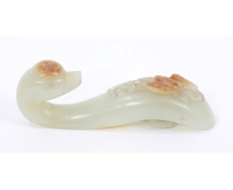 Chinese carved green jade buckle in the form of a dragon, a russet inclusion carved as a bat, 9cm long, probably 19th century