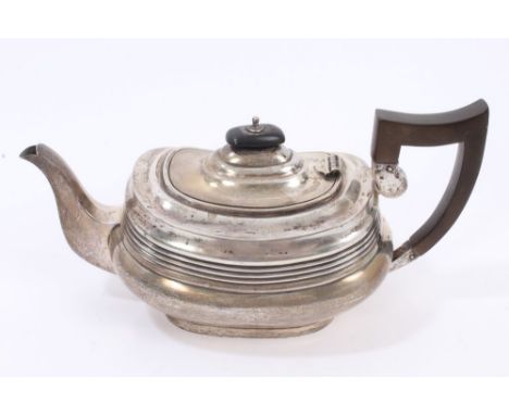 1920s silver teapot of compressed cauldron form, with bands of reeded decoration, with ebony handle and domed hinged cover wi