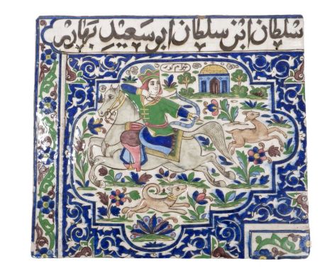 Antique Iznik glazed pottery tile decorated in relief with horseman hunting a deer with hound, with floral scrollwork border 
