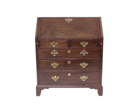George III mahogany bureau with hinged fall, enclosing fitted interior of short drawers and pigeon holes, having two short ov
