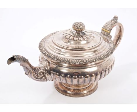 George IV Scottish silver teapot of compressed baluster form, with half fluted decoration, foliate border, decorative spout w