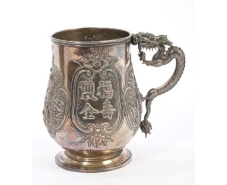Late 19th / early 20th century Chinese silver mug of baluster form, with embossed panel of Chinese characters and figurative 