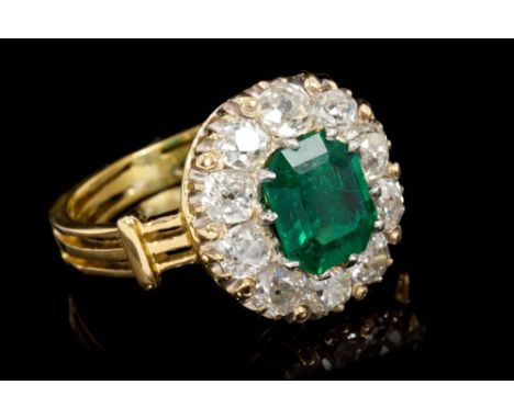 Victorian-style emerald and diamond cluster ring, with an octagonal step cut emerald estimated to weigh approximately 1 carat