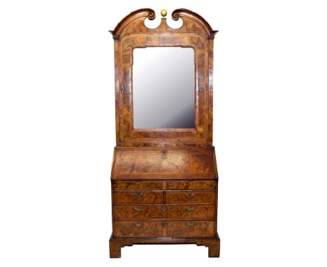 Good early 18th century walnut bureau cabinet, the upper section with broken arch concave moulded pediment centred by gilt ba