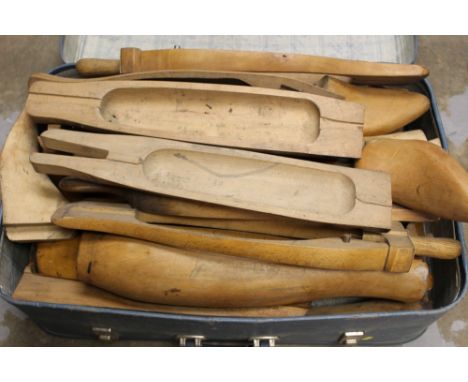 Suitcase containing several pairs of vintage wooden hunting boot trees