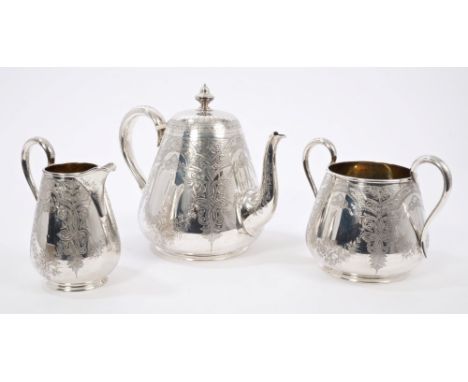 Three piece Victorian silver tea set - comprising teapot of carved form, with floral and Celtic scroll decoration, silver scr