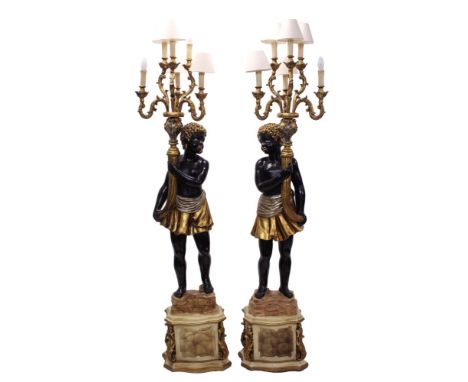 Decorative pair of Venetian-style Blackamoor standard lamps, each painted and gilt-heightened lamp with standing figure holdi