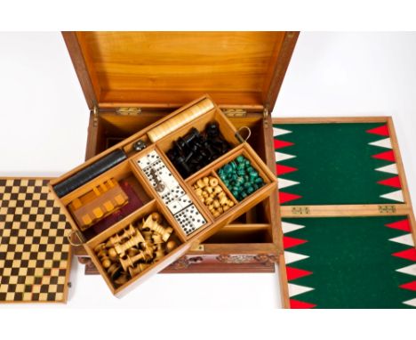 19th century Continental walnut and metal strapwork mounted games compendium, the stepped hinged top centred by coppered plaq