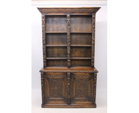 Late 19th century heavily carved oak bookcase with lunette cornice, the upper open section with adjustable shelves, between f