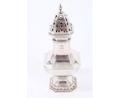 1920s silver sugar caster of octagonal baluster form, pierced slip-in cover with ropework border and urn finial, on an octago