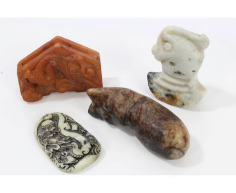 Chinese mottled jade or hardstone carving in the stylised form of a cat, 7cm long, together with three further Chinese hardst