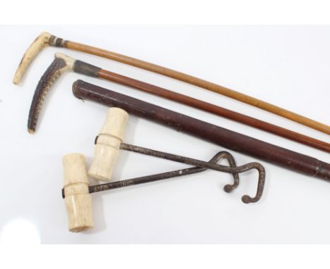 Pair of vintage boot-pulls with turned bone handles, two hunting whips with stag horn handles and one other leather covered w