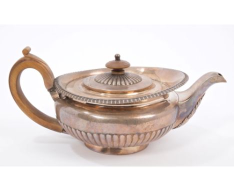 George III silver teapot of compressed campana form, with half fluted decoration, gadrooned border, short spout with acanthus