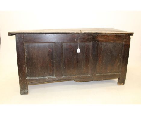 Substantial 17th / 18th century oak coffer, plank lid with iron strap clasp and triple panel front, raised on stiles, 145cm w