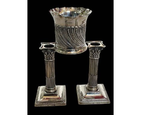 Pair of silver loaded candlesticks, mark worn London 1897?, and Edwardian silver wine bottle holder, London 1903.