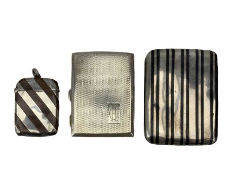 Early 20th century niello work cigarette case, tests as silver, a plated and niello work vesta case and another engine turned