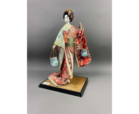 JAPANESE DOLL IN SILK ROBES,on a wood stand Condition report: Scuffs and deterioration of finish to hands, back of upper back