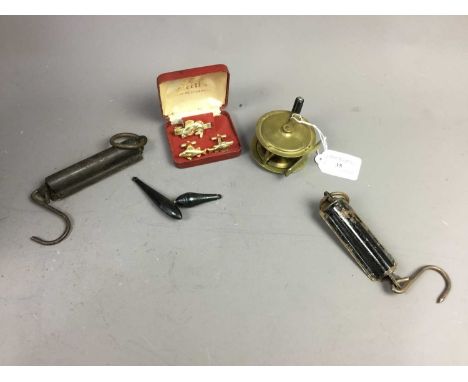 BRASS FISHING REEL,6.5cm diameter, along with a set of cufflinks and tie slide, modelled with fish, and two scales and floats