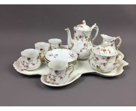 FRENCH CABARET TEA SERVICE,with floral decoration on a white ground, along with a walking ware lidded pot and cup 