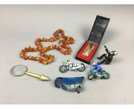 ROUGH CUT BALTIC AMBER NECKLACE,along with a lighter, motorcycle toys, magnifying lens and other objects 