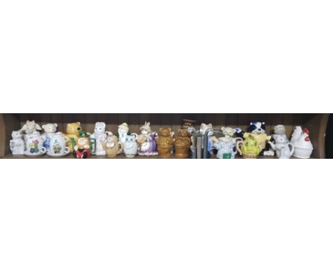 Shelf of ceramic character pots with lids, mainly animals 