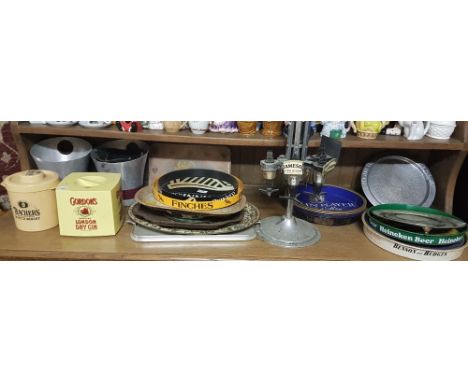 Shelf of bar items – ice buckets, advertisings trays (Gordons etc), circular optic stand etc