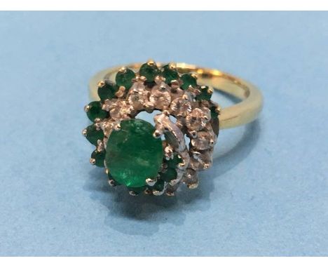 An 18ct ring, mounted with diamonds and emeralds