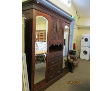 WALNUT COMPENDIUM WARDROBE CENTRALLY FITTED WITH TWO HEAVILY CARVED DOORS WITH OPEN SHELF WITH A CHEST OF TWO OVER THREE FULL