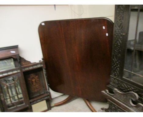 GEORGIAN MAHOGANY SQUARE TILT TOP TABLE WITH A SPLAYED TRIPOD BASE AND BRASS CAPPED CASTERS 