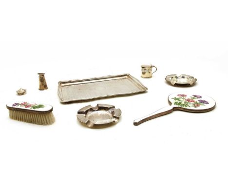 A silver dressing table tray, a pair of ashtrays, Sheffield 1964, a mustard pot, a pepperette, a silver and enamel dressing m