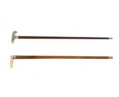 A 19th century walking stick, the walrus ivory handle unscrewing to reveal a collection of six marbles housed within the mala