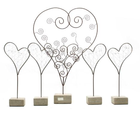 A pair of modern silvered wire heart sculptures on cement plint bases, 18cm wide x 44cm high and a larger modern heart sculpt