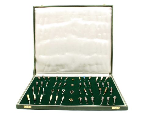 A cased collection of button hooks with various handles, to include agate, silver, mother of pearl and enamel, to include rec