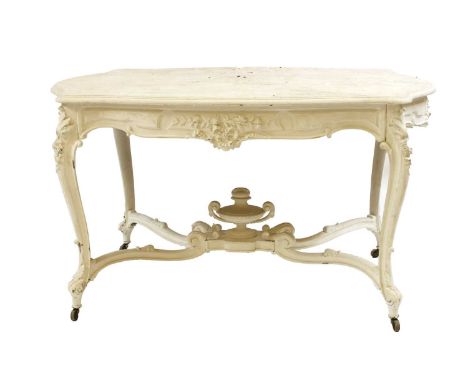 A 19th century white painted oval centre table, of shaped oval outline and carved frieze decoration, on swept legs with a cen