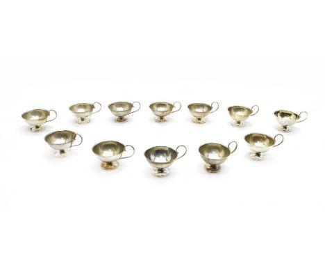 A set of twelve Swedish silver tot cups, by K&amp;E Carlson, with scroll handles, Swedish assay marks 1954-1957, 8.5cm wide, 