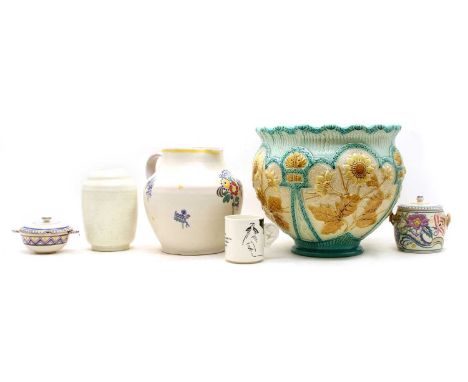 A collection of Poole Pottery comprising of a jug with flowerhead detail, 22cm high, a preserve jar and cover with banded geo