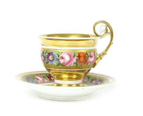 A Russian porcelain cup and saucer, with gilt and enamel decoration, 19th century, 9cm and a pair of Victorian brass candlest