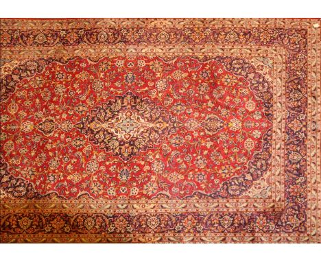 A Persian Kashan carpet,20th century, the field woven with a central medallion and scrolling foliate motifs, within seven sim