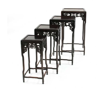 A quartetto nest of Chinese hardwood tables, 20th century, each square top above a pierced frieze carved with bats and auspic