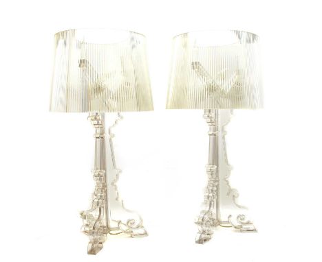 A pair of Lucite table lamps and shades, the cylindrical fluted shades on triform branch descending onto a column and triform