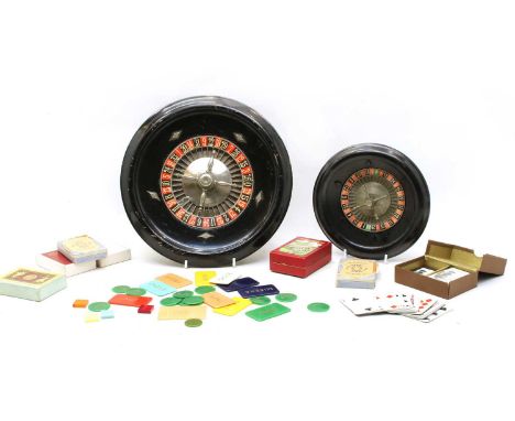 A collection of gaming items, to include two table top roulette wheels, various counters and playing cards Condition report: 