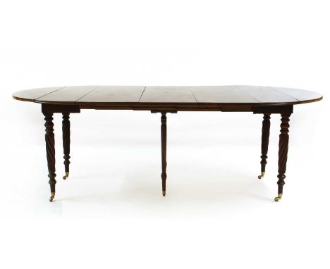 A small George lll and later mahogany dining table, pulling out with three leaves, on four turned spiral legs, and two added 