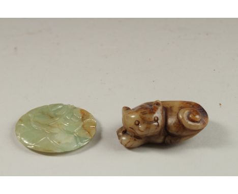 A FINELY CARVED CHINESE JADE ROUNDEL - POSSIBLY CHING DYNSATY, and another carved jade dog, (2)