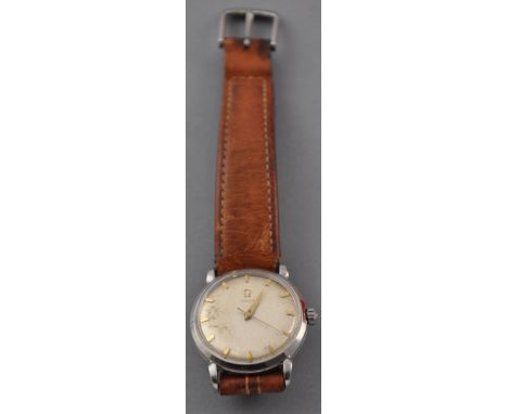 A gentlemans Omega stainless steel wristwatch, circa 1950, the champagne dial with gilt baton numerals