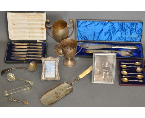 A quantity of silver and platedware including, a boxed set of silver tea spoons, two photograph framed,  two trophy cups, a p