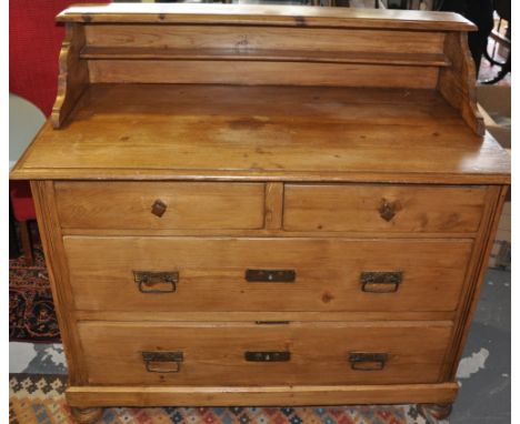 A late 19th Century East European pine chest of drawers with raised shelf back over 2 short and 2 long drawers on flat bun fe