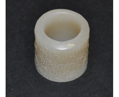 A carved jade archer's finger ring.